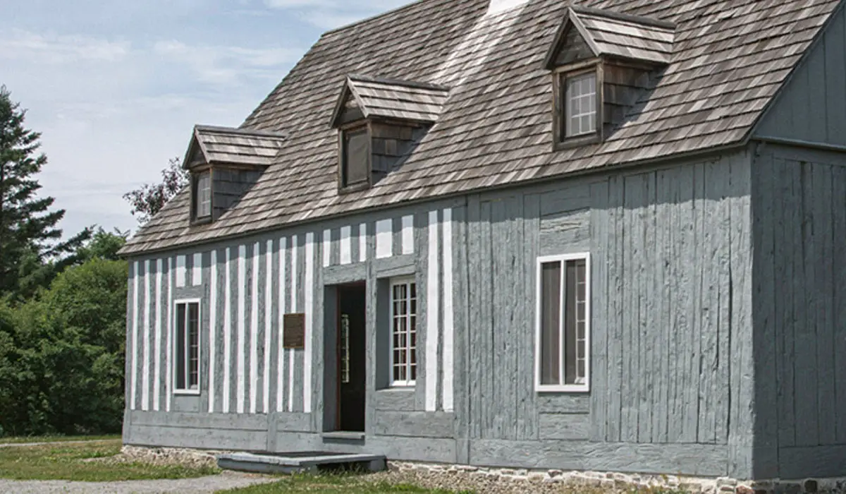 a grey walled house with cedar shingles