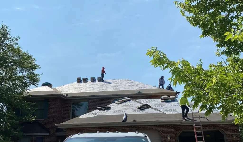 professional roofers on top of the roof for roof replacement