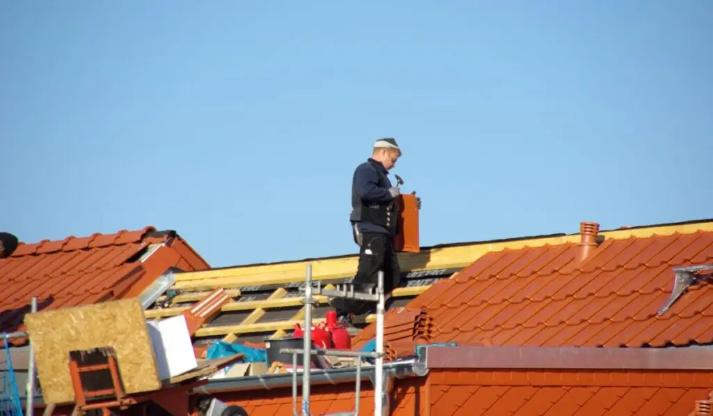 a professional roofer replacing a roof from a house