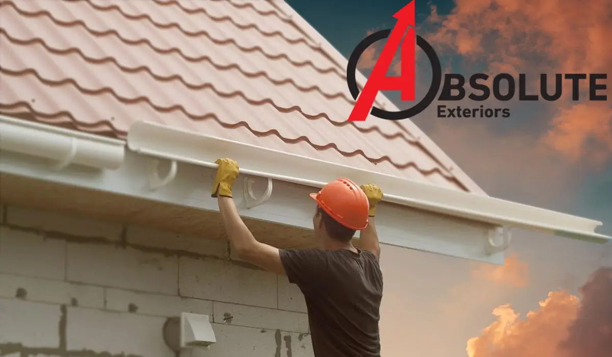 an image of a man fixing the roof gutter and a logo of Absolute Exteriors